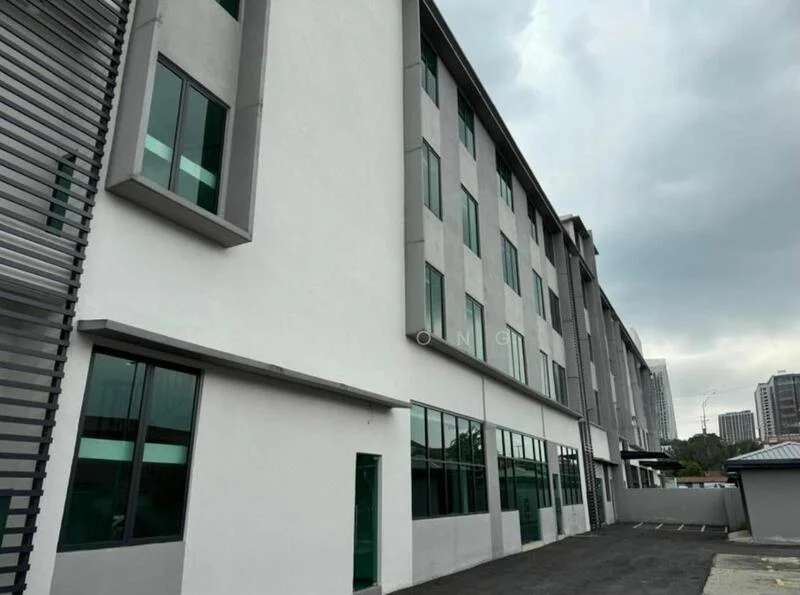 Exterior type: low-rise apartment block; features: grey painted facade, large windows with green frames, multiple storeys, asphalt parking area, surrounding urban context, flat roof, entrance door, sidewalk, adjacent buildings in background; style: modern.